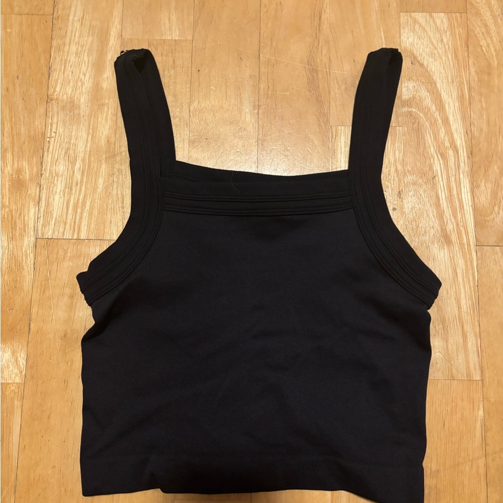 Out from under black tank top